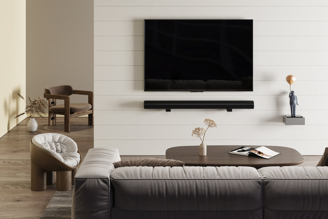 a living room with a large flat screen tv and soundbar mounted on the wall 