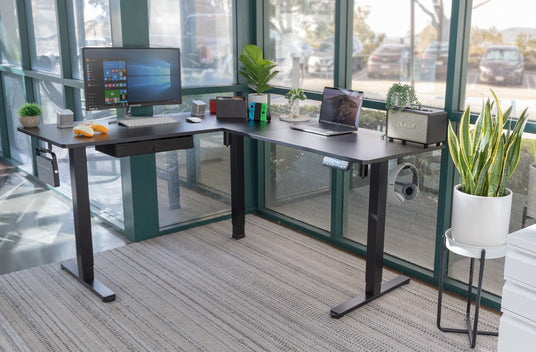 a corner standing desk with a computer on top of it