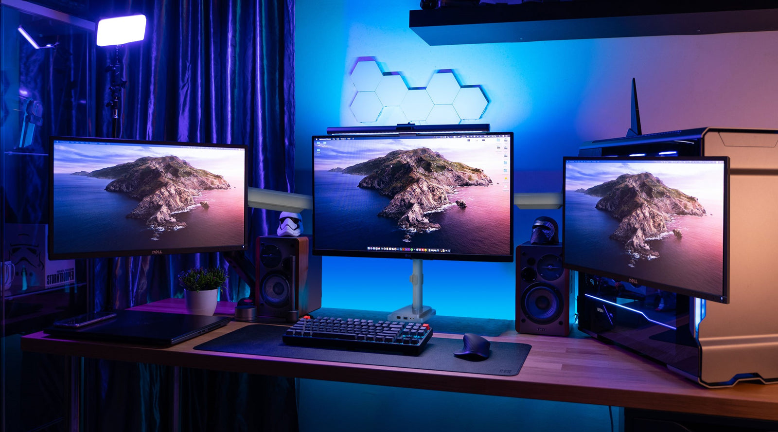 a computer desk with two monitors and a keyboard