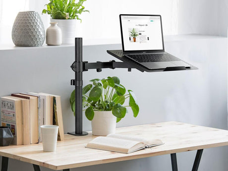 a laptop computer sitting on top of a wooden desk