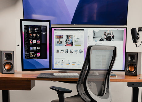 a computer desk with two monitors and a keyboard