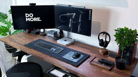 a wooden desk topped with a computer monitor and keyboard