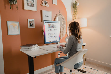 a woman sitting at a desk using a computer