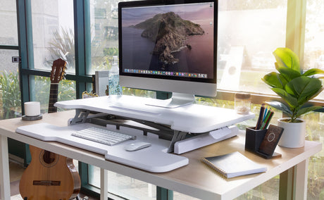 a computer desk with a keyboard and a monitor