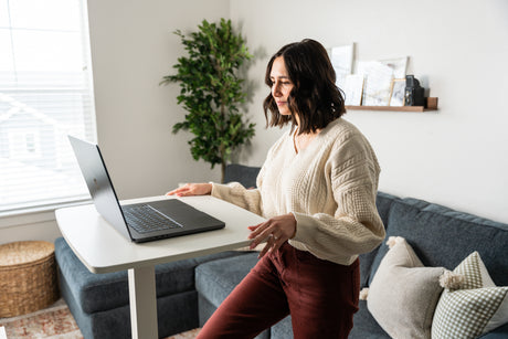 a woman sitting on a couch using a laptop