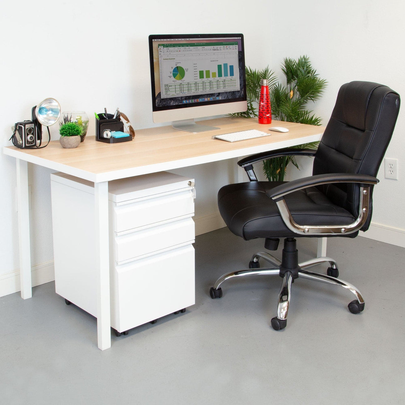 a desk with a chair and a computer on it