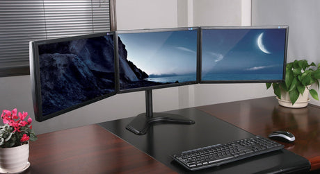 a desk with a computer monitor and keyboard on it