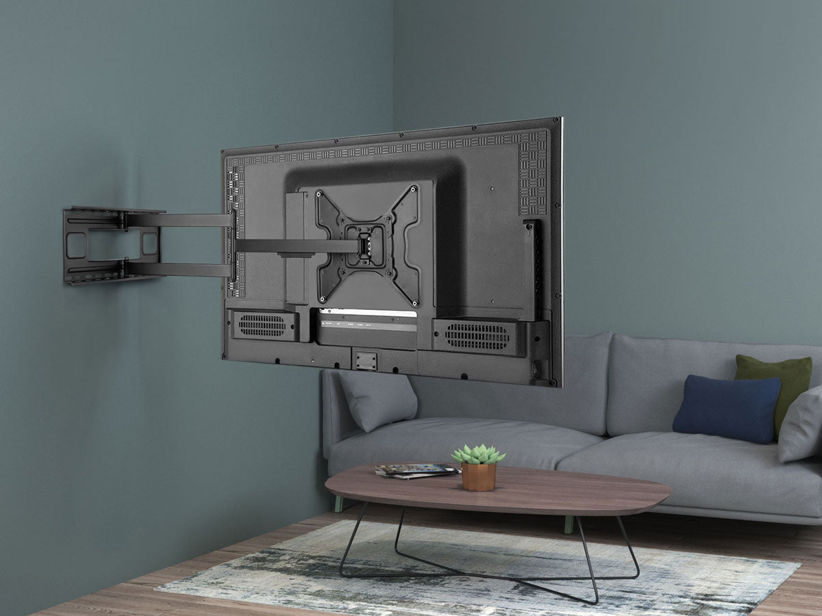 a living room with a couch and a tv mounted to the wall