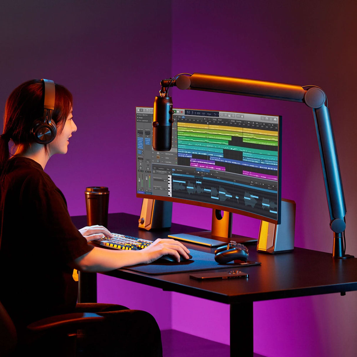 a woman sitting in front of a computer monitor with headphones on